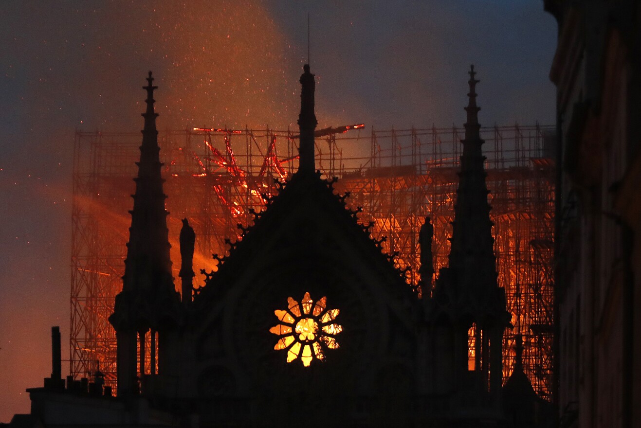 Flames and smoke rise from Notre Dame cathedral as it burns in Paris, Monday, April 15, 2019.